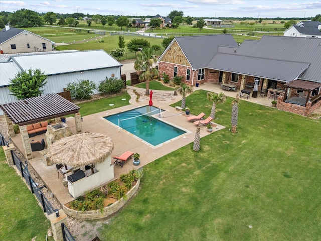 view of swimming pool with a gazebo, a fireplace, a patio, and a lawn