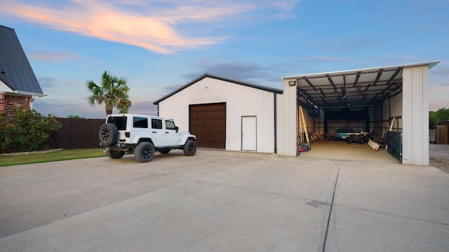 view of garage at dusk