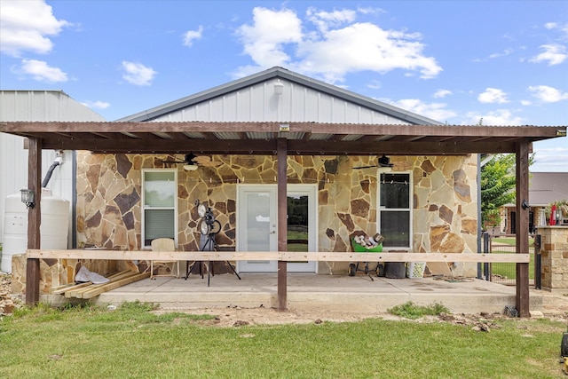 rear view of house with a lawn and ceiling fan