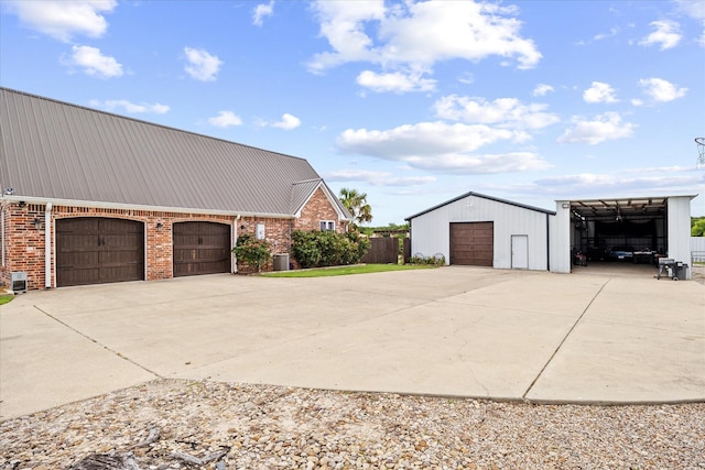 9557 Smith Rd, Royse City, TX 75189 - view of home's exterior with metal roof, driveway, a garage, and brick siding