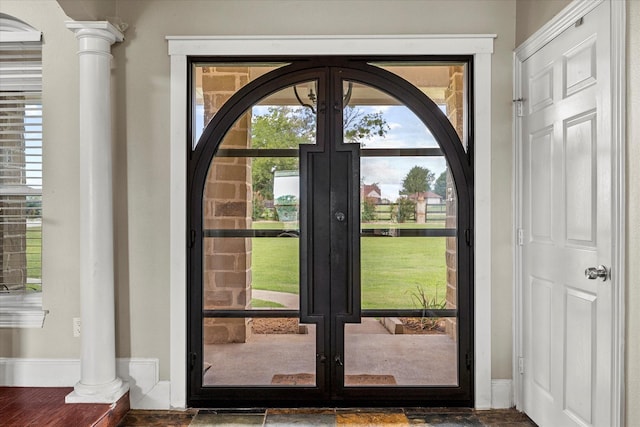 doorway featuring decorative columns and french doors