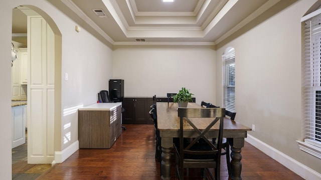 dining space featuring crown molding, dark hardwood / wood-style floors, and a tray ceiling