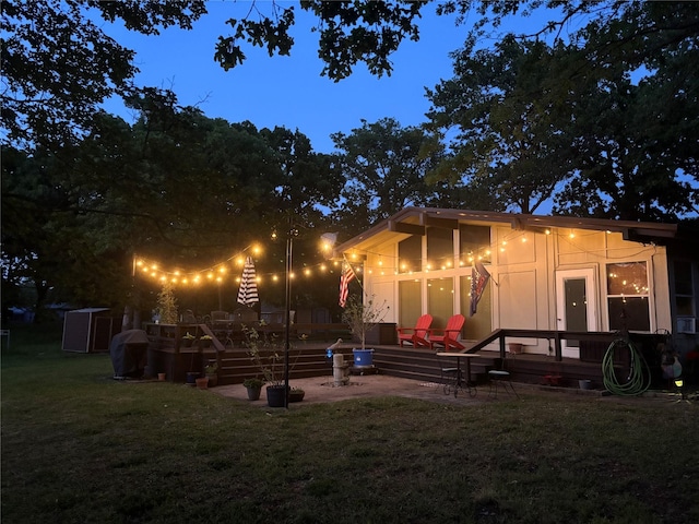 rear view of property featuring a patio area and a yard