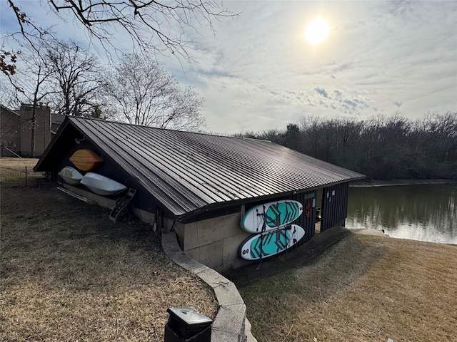 view of side of property featuring a water view and metal roof