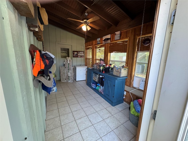 sunroom / solarium featuring beam ceiling