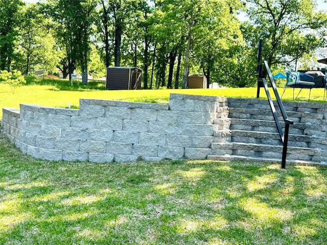 view of storm shelter with a storage shed, a yard, and an outdoor structure