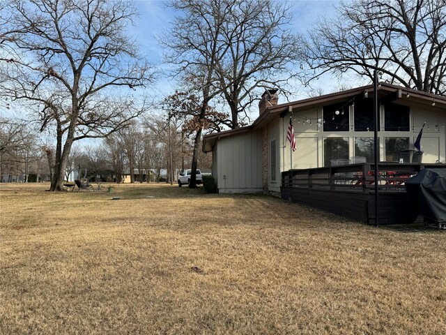 view of side of property with a yard