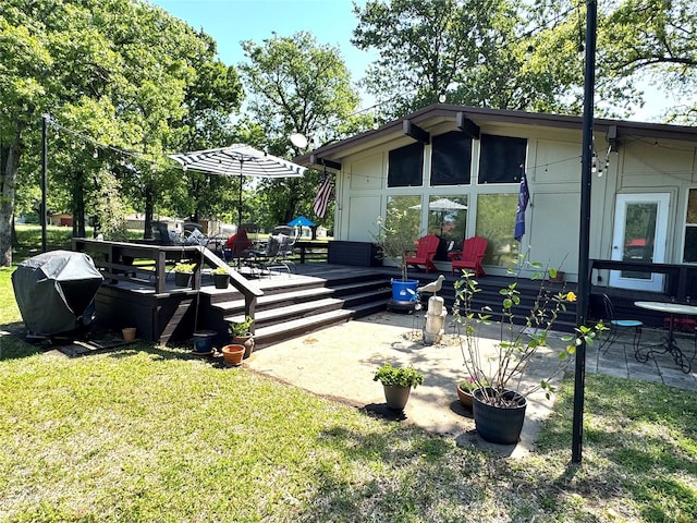 view of property exterior with a yard and a wooden deck