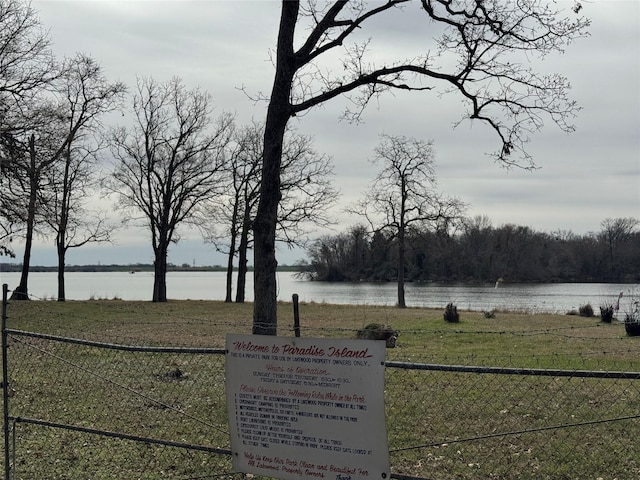 view of yard featuring a water view and fence