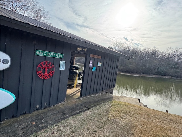 exterior space featuring a water view and metal roof