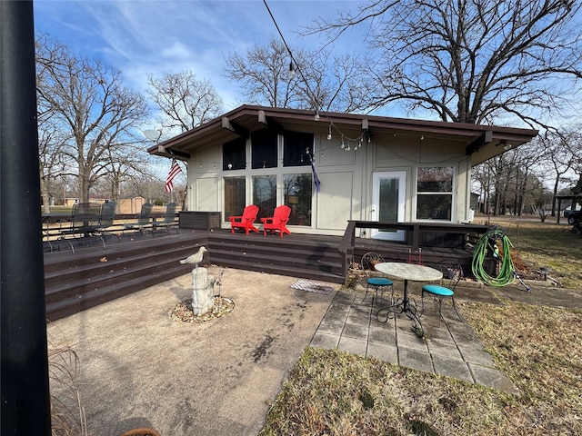 back of house featuring a wooden deck