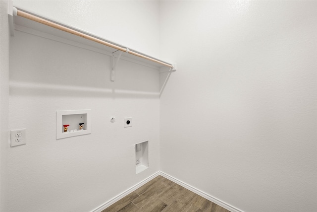 clothes washing area featuring gas dryer hookup, washer hookup, hookup for an electric dryer, and hardwood / wood-style floors