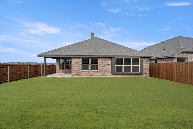 back of property featuring a lawn and a patio