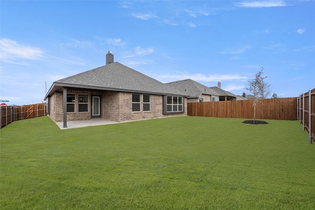 back of property with a patio and a yard