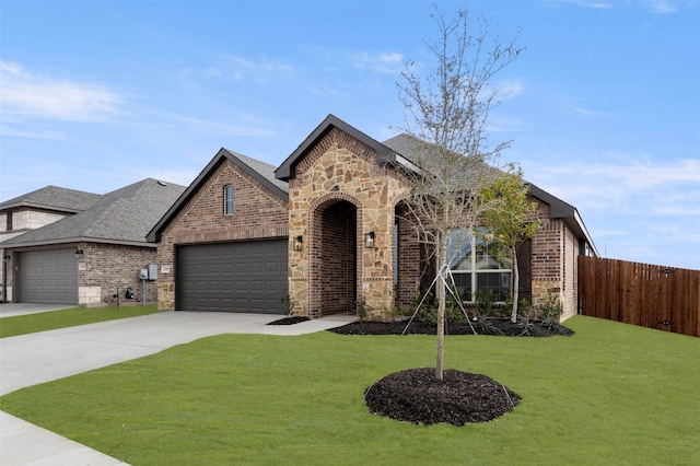 view of front of property with a garage and a front yard