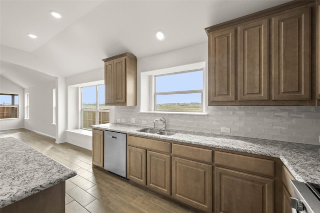 kitchen featuring tasteful backsplash, a healthy amount of sunlight, dishwasher, and sink