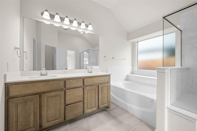 bathroom with plus walk in shower, lofted ceiling, tile patterned floors, and vanity