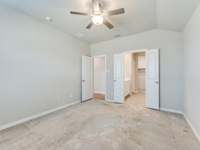 unfurnished bedroom with light carpet, lofted ceiling, and ceiling fan