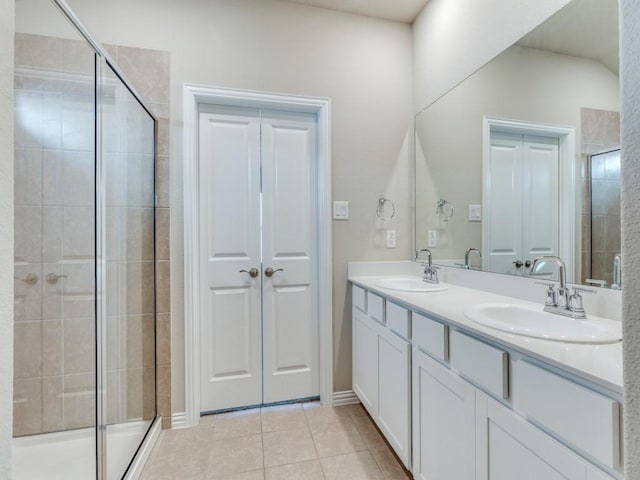 bathroom featuring walk in shower, vanity, and tile patterned flooring