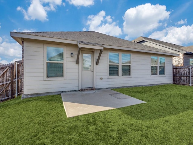 back of property featuring a yard and a patio area