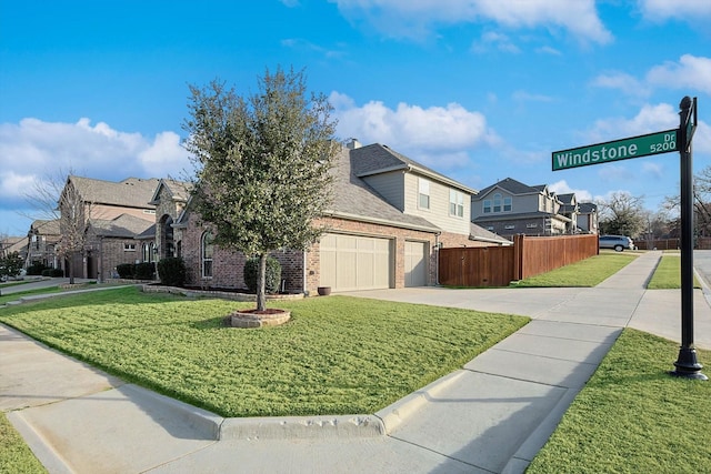 view of front of home with a garage and a front lawn