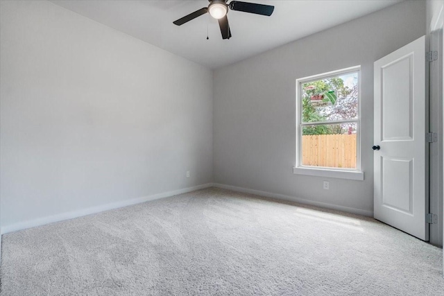 unfurnished room with ceiling fan and light carpet