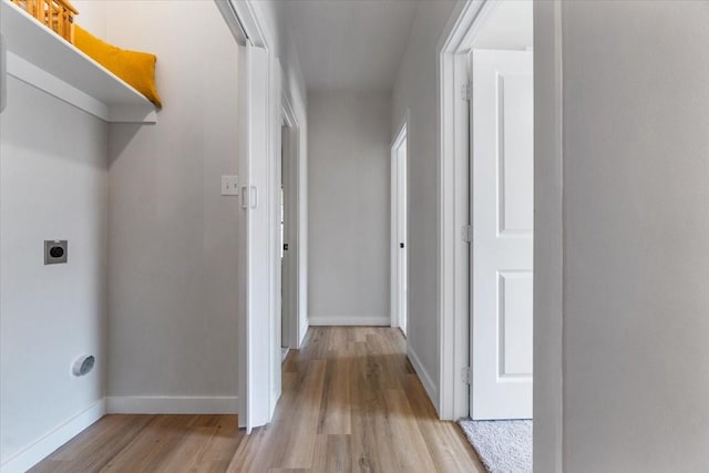 laundry area featuring hookup for an electric dryer and light wood-type flooring