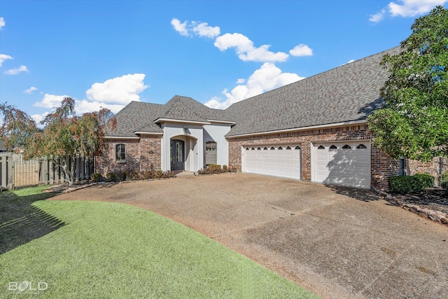 view of front facade featuring a garage and a front lawn