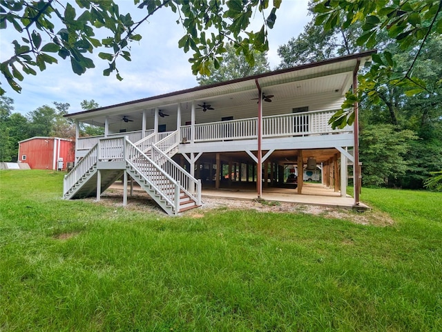 rear view of house featuring a wooden deck, a yard, ceiling fan, and a storage shed