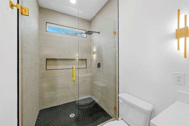 bathroom with an enclosed shower and toilet