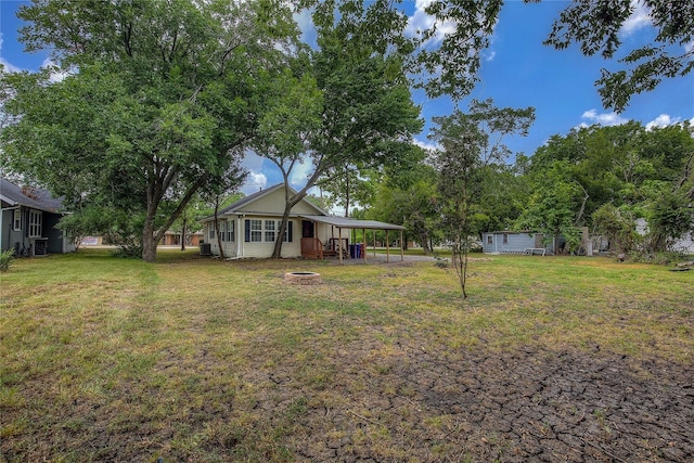 view of yard with a fire pit