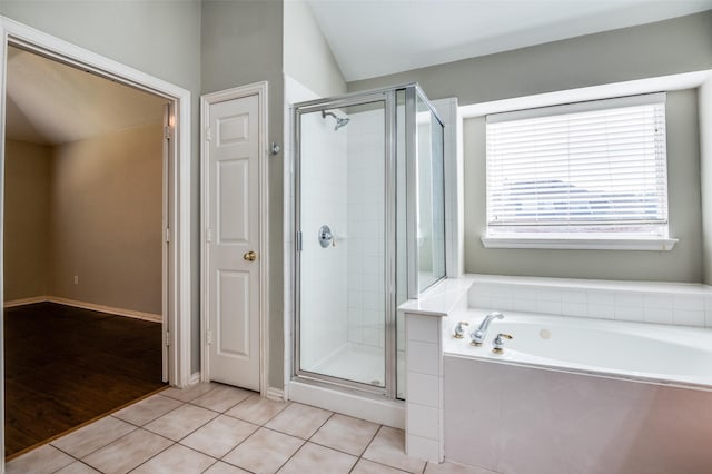 bathroom featuring tile patterned flooring, lofted ceiling, and plus walk in shower