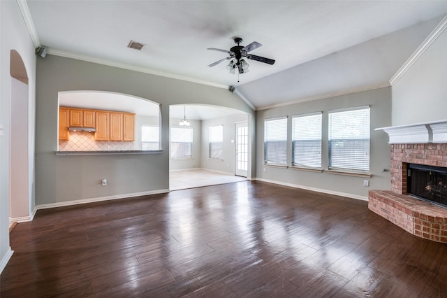 unfurnished living room featuring vaulted ceiling, plenty of natural light, and crown molding