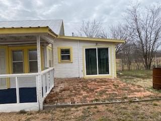 back of property with a sunroom