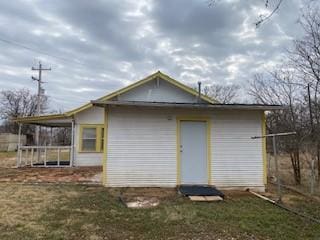 rear view of house featuring a yard