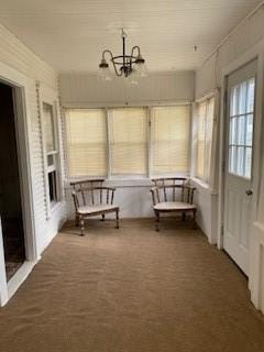 unfurnished sunroom featuring a notable chandelier