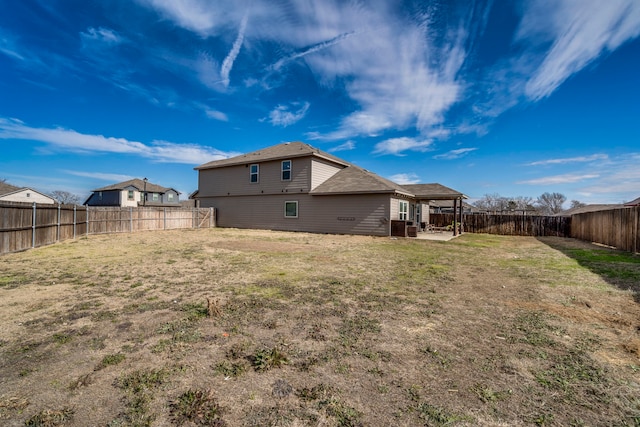 rear view of house with a lawn and a patio