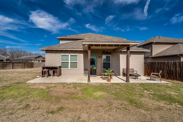 rear view of property featuring a bar, a yard, and a patio