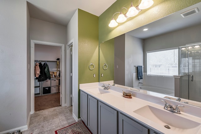 bathroom with tile patterned floors, vanity, and shower with separate bathtub