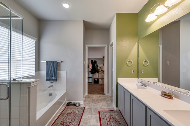 bathroom with vanity, tile patterned floors, and plus walk in shower