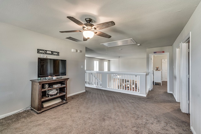 living room with a textured ceiling and carpet