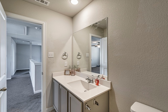 317 Countryside Dr, Aubrey, TX 76227 - half bathroom featuring a textured wall, vanity, toilet, and a ceiling fan