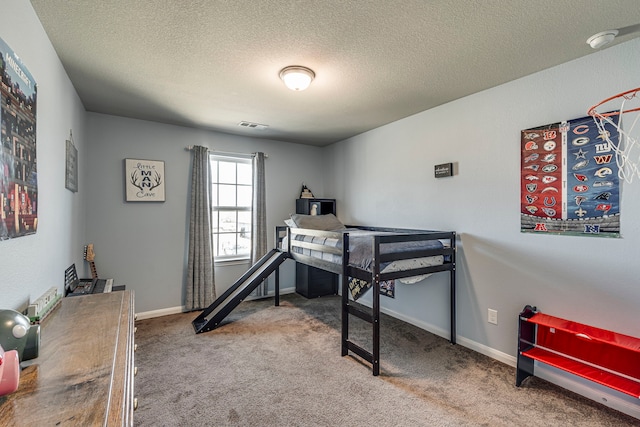 bedroom featuring carpet and a textured ceiling