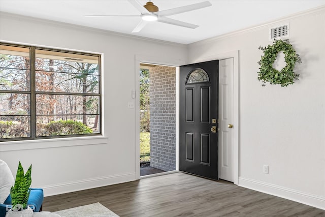 foyer entrance featuring ornamental molding, dark hardwood / wood-style floors, and ceiling fan