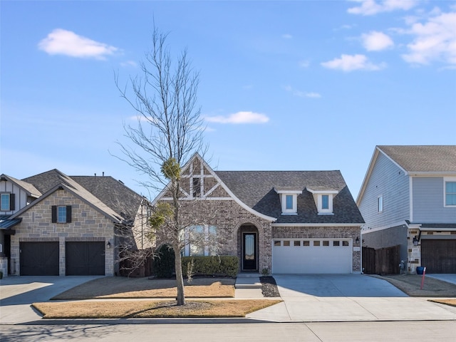 view of front of property with a shingled roof, concrete driveway, brick siding, and a garage