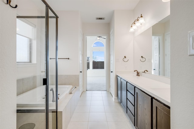 full bath featuring a garden tub, plenty of natural light, visible vents, and tile patterned flooring