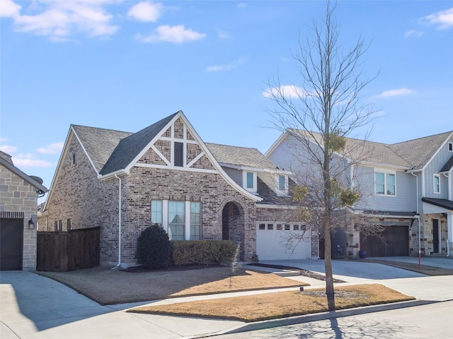 view of front facade featuring an attached garage, brick siding, fence, concrete driveway, and roof with shingles