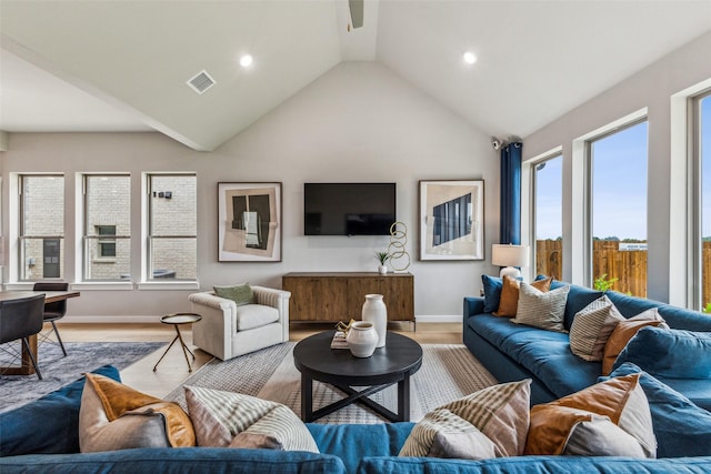 living room with lofted ceiling and light wood-type flooring