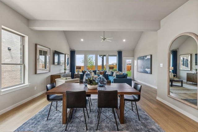 dining area featuring wood-type flooring, lofted ceiling with beams, and a wealth of natural light