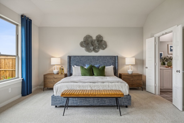 bedroom featuring multiple windows, vaulted ceiling, and carpet